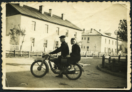USSR - CIRCA 1970s: An antique photo shows  Man and woman riding on a motorcycle, USSR, circa 1970sのeditorial素材