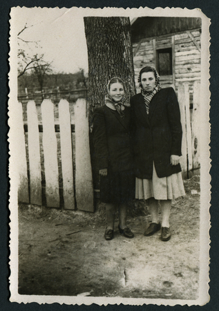 USSR - CIRCA 1980s: An antique photo shows Two women near fence, USSR, circa 1980sのeditorial素材