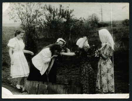 USSR - CIRCA 1950s: An antique photo shows woman drinking water from a well