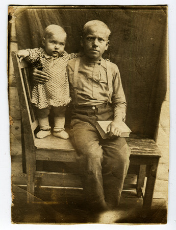 Ussr - CIRCA 1930s: An antique Black & White photo show father with a small daughterのeditorial素材