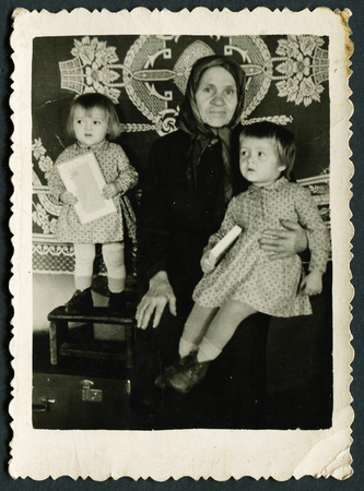 USSR - CIRCA 1960s: An antique photo show grandmother with two grandchildrenのeditorial素材