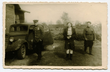 Ussr - CIRCA 1940s: An antique Black & White photo show soldiers near the machineのeditorial素材