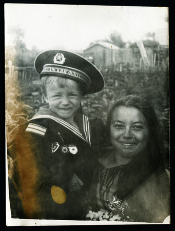 USSR - CIRCA 1960s: An antique photo shows Mom and son in a suit Navyのeditorial素材