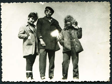 USSR - CIRCA 1980s: An antique photo  shows young man and two young girls on the hill