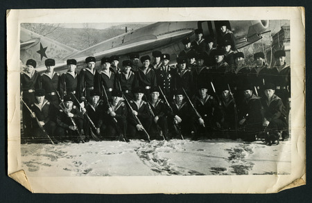 Ussr - CIRCA 1960s: An antique Black & White photo show Group portrait of the soldier against the...