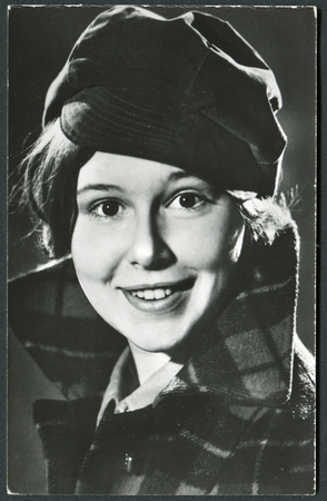 USSR - CIRCA 1960s: studio Portrait of a beautiful yung woman in a hat and coat, circa 1960sのeditorial素材