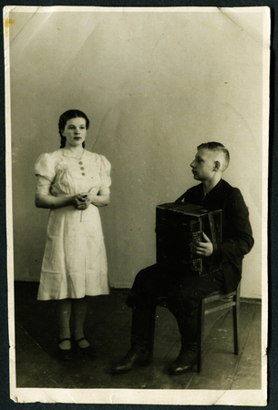 USSR - CIRCA 1950s An antique photo shows boy playing the harmonica for girls, USSR, 1950sのeditorial素材
