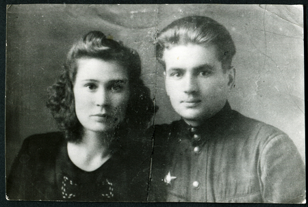 MOSCOW - CIRCA 1973: Studio portrait of a young family, Russia, USSR, 1960のeditorial素材