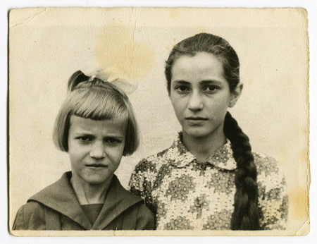 CIRCA 1954: An antique photo shows studio portrait of a two girlsのeditorial素材