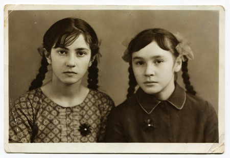 CIRCA 1950s: An antique photo shows studio portrait of a two sisters.のeditorial素材