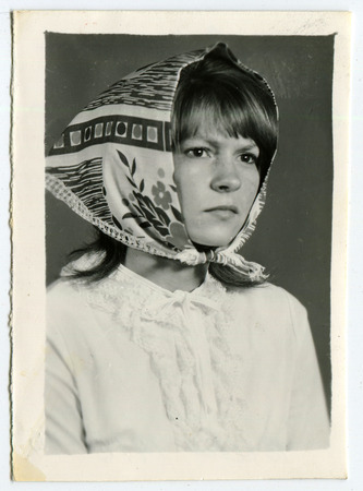 Ussr - CIRCA 1970s: An antique Black & White photo show portrait of a beautiful young girl in a scarfのeditorial素材