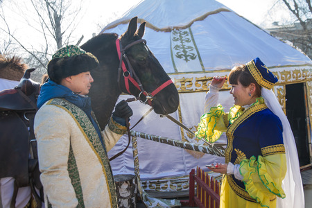 PETROPAVLOVSK, KAZAKHSTAN - MARCH 21, 2015: celebration of the new year on the solar calendar astronomical in Iranian and Turkic peoples. The girl stroking horseのeditorial素材