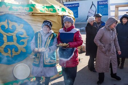PETROPAVLOVSK, KAZAKHSTAN - MARCH 21, 2015: celebration of the new year on the solar calendar astronomical in Iranian and Turkic peoples. women cook baursaksのeditorial素材