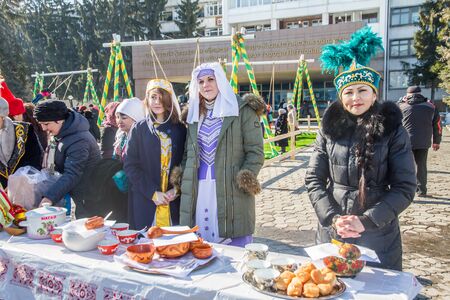 PETROPAVLOVSK, KAZAKHSTAN - MARCH 21, 2015: celebration of the new year on the solar calendar astronomical in Iranian and Turkic peoples. Girls are treated passersのeditorial素材