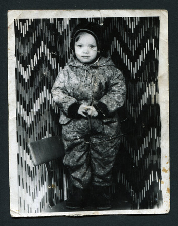 USSR - CIRCA 1960s: An antique photo shows little girl on a chair, circa 1960sのeditorial素材