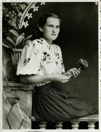Ussr - CIRCA 1970s: An antique Black & White photo show studio portrait of a beautiful young girl with a roseのeditorial素材