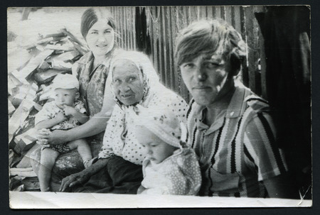 Ussr - CIRCA 1970s: An antique Black & White photo show family sitting on a benchのeditorial素材