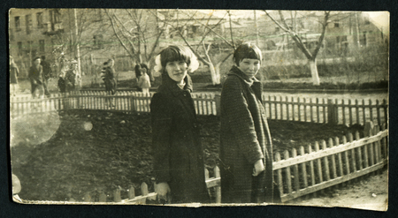 Ussr - CIRCA 1980s: An antique Black & White photo show two young girls on a walkのeditorial素材
