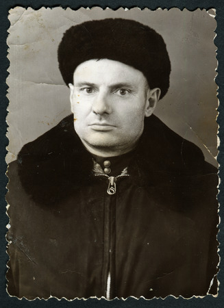 Ussr - CIRCA 1970s: An antique Black & White photo show studio portrait of a man in winter clothesのeditorial素材