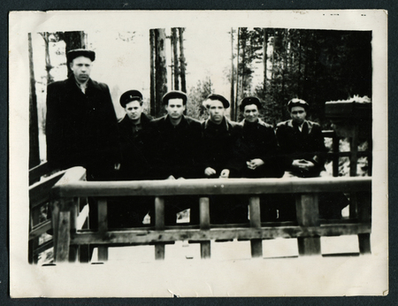 USSR - CIRCA 1950s An antique photo shows group of men on the porchのeditorial素材
