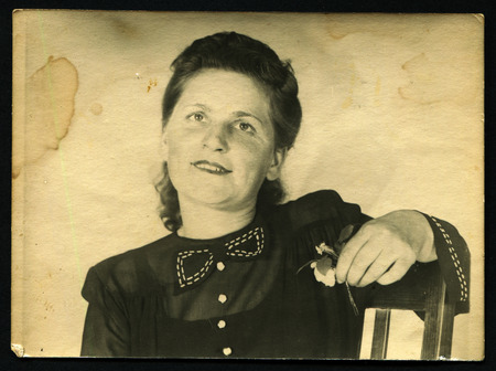 Ussr - CIRCA 1970s: An antique Black & White photo show mysterious woman with a small flowerのeditorial素材