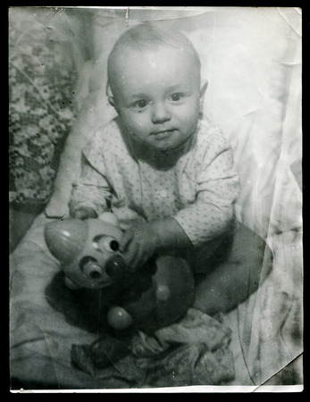 Ussr - CIRCA 1970s: An antique Black & White photo show little baby with toyのeditorial素材