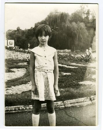Ussr - CIRCA 1980s: An antique Black & White photo show Girl walks in the parkのeditorial素材