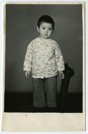 USSR - CIRCA 1950s: The little boy standing on a chair, circa 1950sのeditorial素材