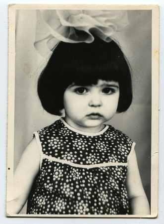 USSR - CIRCA 1980s: Vintage photo of little girl with bowのeditorial素材