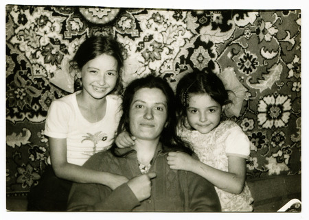 Ussr - CIRCA 1970s: An antique Black & White photo show young mother with her two daughtersのeditorial素材