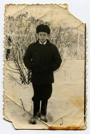 Ussr - CIRCA 1970s: An antique Black & White photo shows a boy outdoorsのeditorial素材