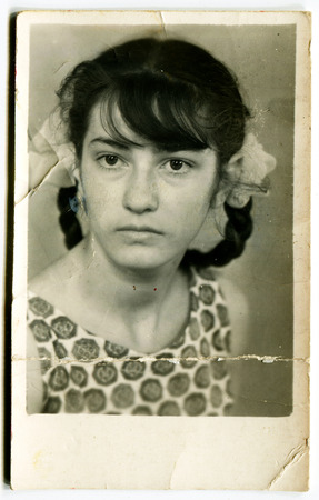 Ussr - CIRCA 1980s: An antique Black & White photo show girl with pigtails and bowsのeditorial素材