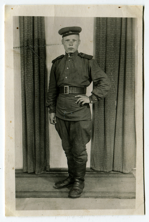 USSR - CIRCA 1960s: An antique photo shows studio portrait of a soviet Army soldier.