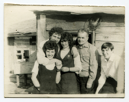 Ussr - CIRCA 1980s: An antique Black & White photo show family portrait on the background of the...