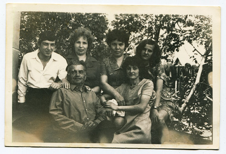 Ussr - CIRCA 1970s: An antique Black & White photo show family portrait in the garden