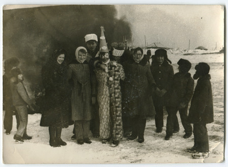 USSR - CIRCA 1980s: An antique photo shows  winter holiday with a clown outdoors, USSR, circa 1980sのeditorial素材