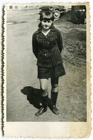 USSR - CIRCA 1980s: An antique photo show girl walking on the street, USSR, circa 1980sのeditorial素材