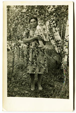 USSR - CIRCA 1970s: An antique photo shows  mother and baby daughter in a birch grove, USSR, circa 1970sのeditorial素材