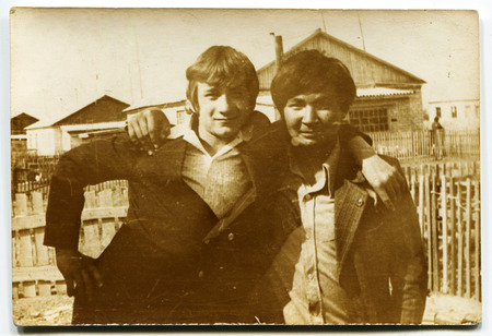 USSR - CIRCA 1970s: An antique photo shows two young men in an embrace, USSR, circa 1970sのeditorial素材