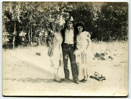 USSR - CIRCA 1980s: An antique photo shows  man and two women in a city park, USSR, circa 1980sのeditorial素材