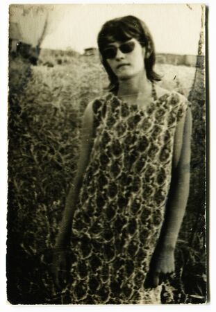 Ussr - CIRCA 1970s: An antique Black & White photo show girl in sunglassesのeditorial素材