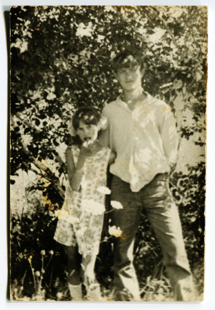 Ussr - CIRCA 1970s: An antique Black & White photo show brother and sister in the gardenのeditorial素材