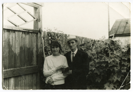 Ussr - CIRCA 1970s: An antique Black & White photo show family in the yardのeditorial素材