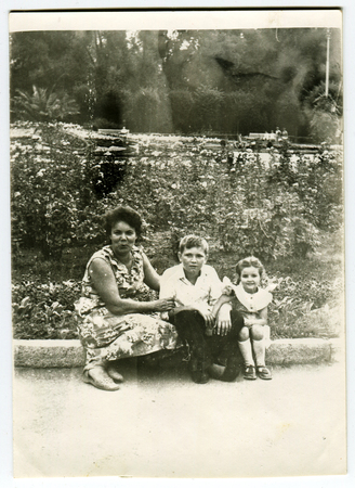 Ussr - CIRCA 1970s: An antique Black & White photo show Mother with children in city parkのeditorial素材