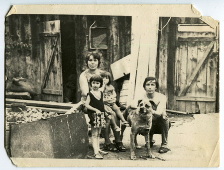 Ussr - CIRCA 1970s: An antique Black & White photo show Family photo with children and a dog in the yardのeditorial素材
