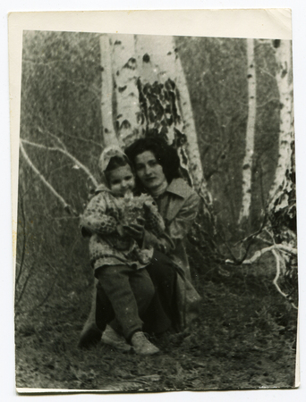 Ussr - CIRCA 1970s: An antique Black & White photo show Mom and daughter in the woods near the birchのeditorial素材