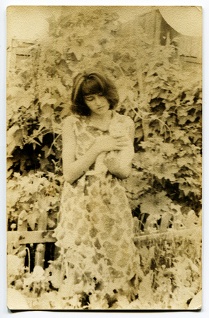 Ussr - CIRCA 1970s: An antique Black & White photo show girl in the gardenのeditorial素材