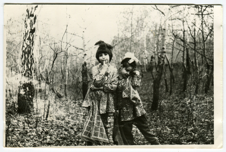 Ussr - CIRCA 1970s: An antique Black & White photo show Two girls play in the woodsのeditorial素材