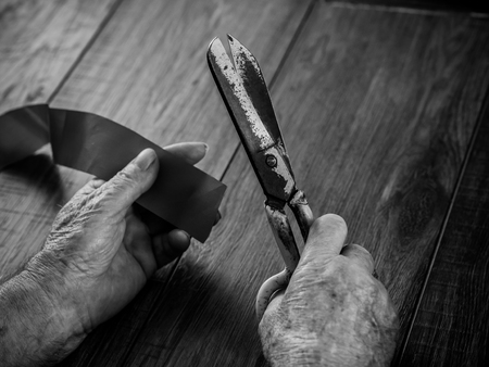 the old man's hand with scissorsの写真素材