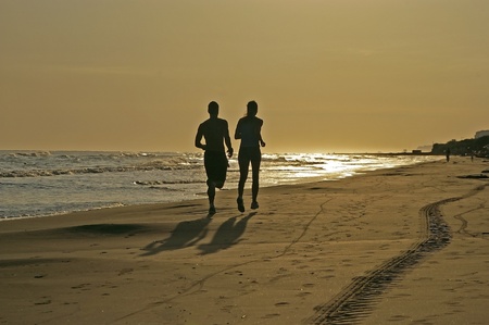 man and woman running on the beachの写真素材